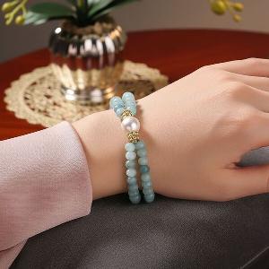 60 Rabatt Flexibles Armband mit weißen Muschelkernperlen und Quarzit